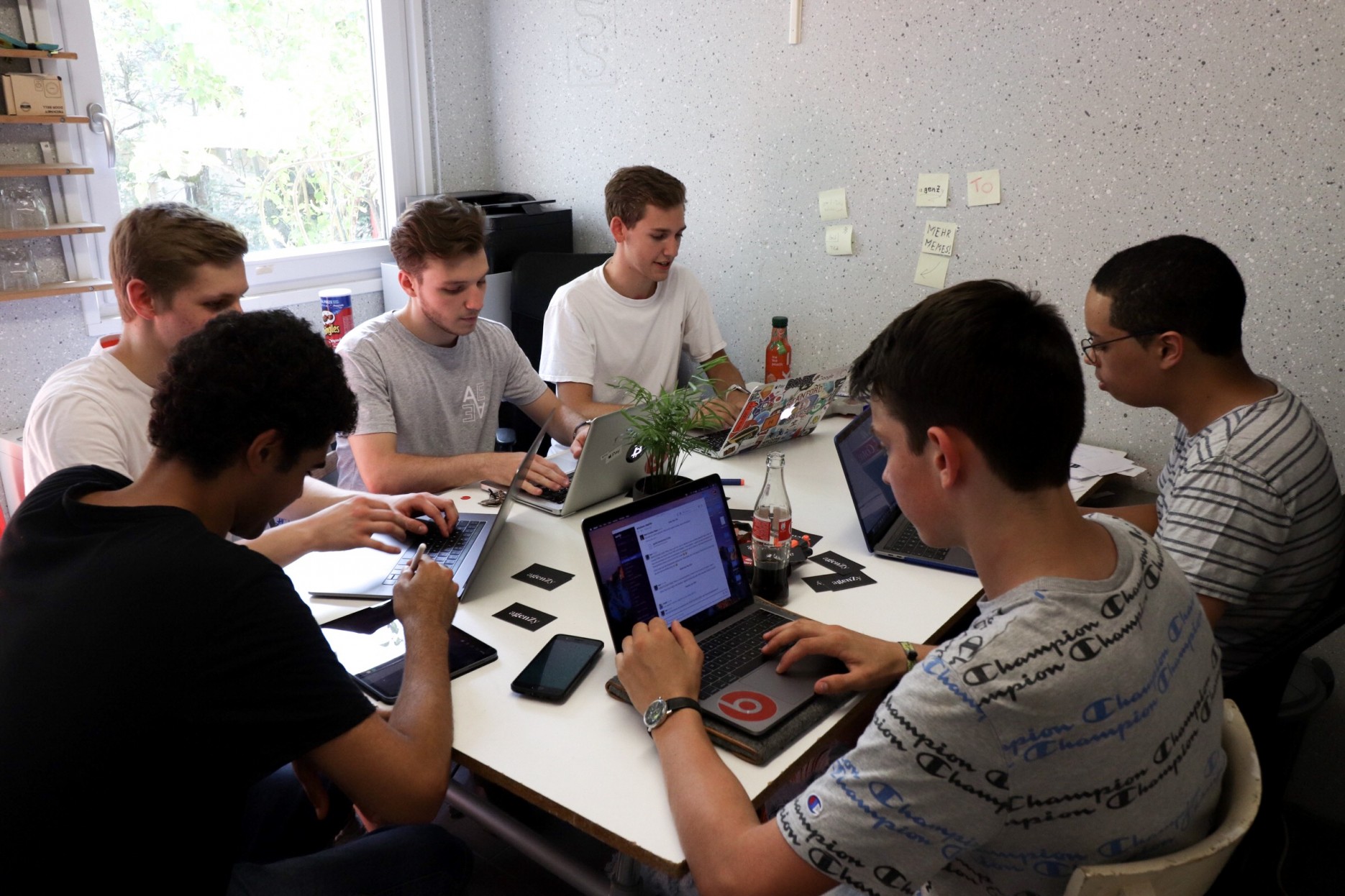 6 young men sitting around a table in the agenZy office